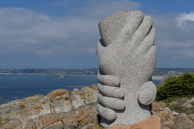 Stone statue of hands grasping each other's wrists