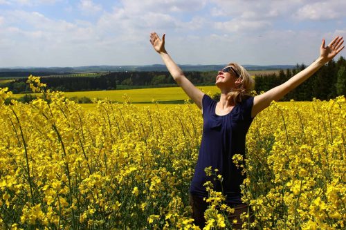 woman worshiping God in field