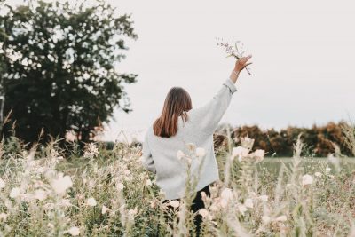 woman in field praising God