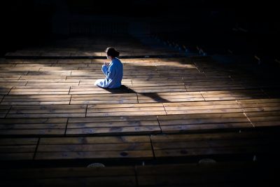 woman kneeling in prayer