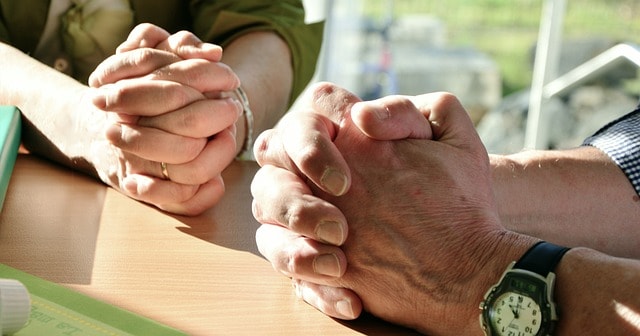 Clasped hands in prayer